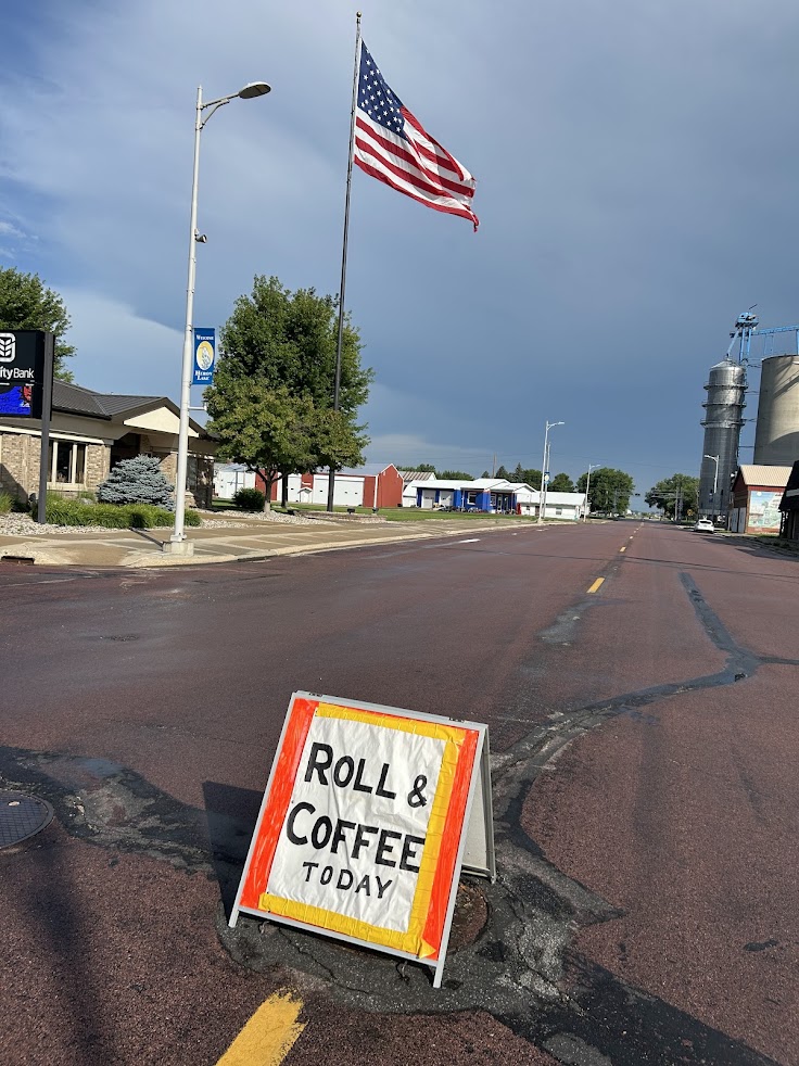 Sign in the street advertising rolls and coffee